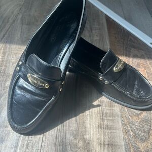 Women’s Michael Kors black leather loafers with gold accent size 9.